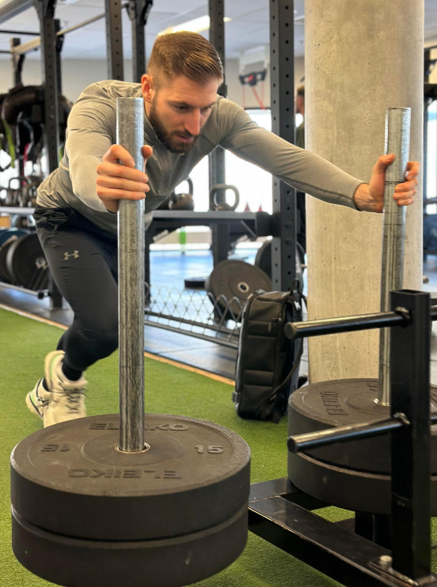 The coach is exercising in the gym.
