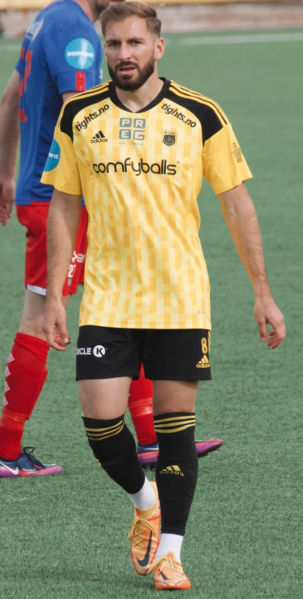 The coach looks serious while he is playing football.